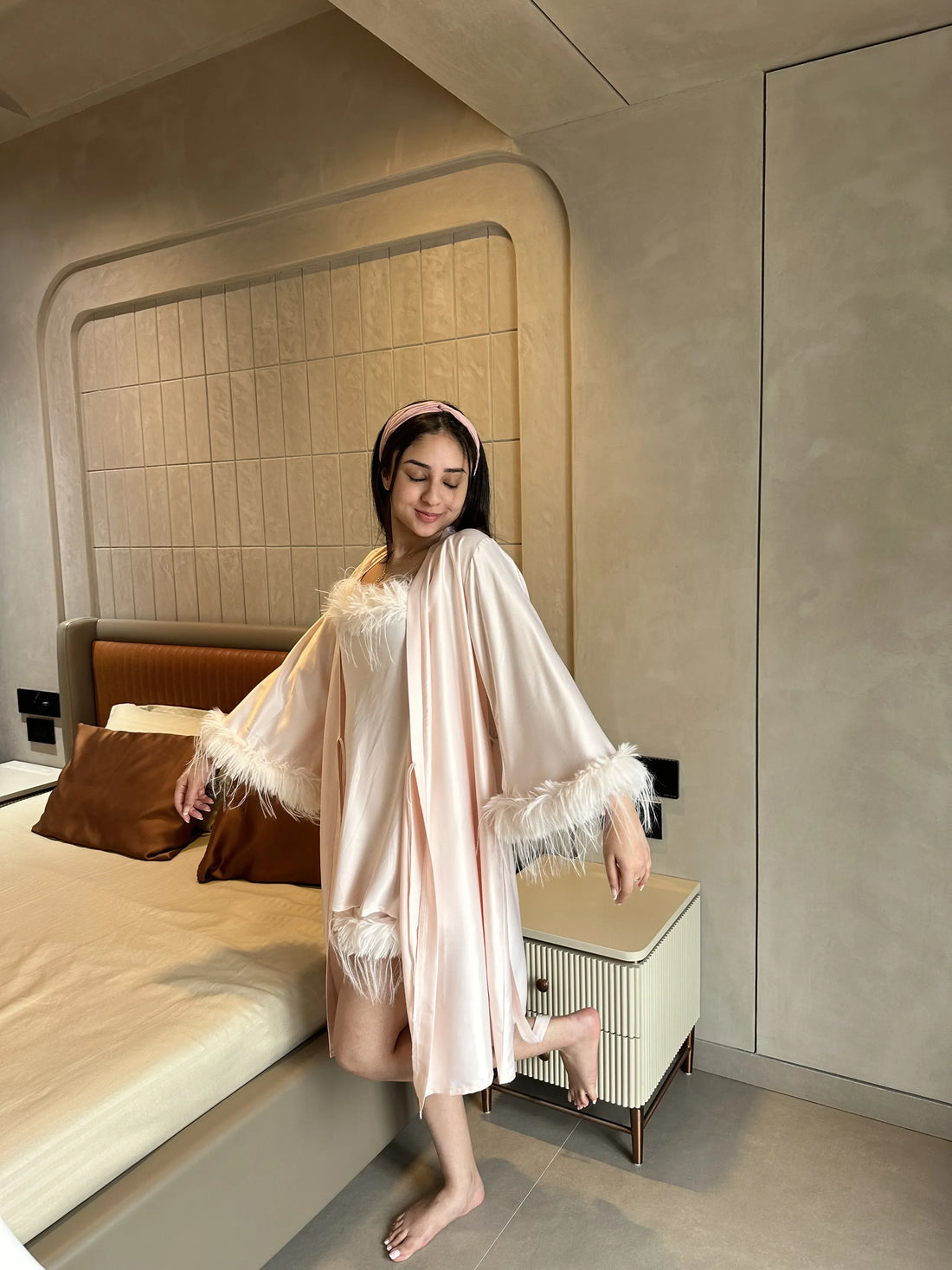 Woman wearing satin robe set with fur