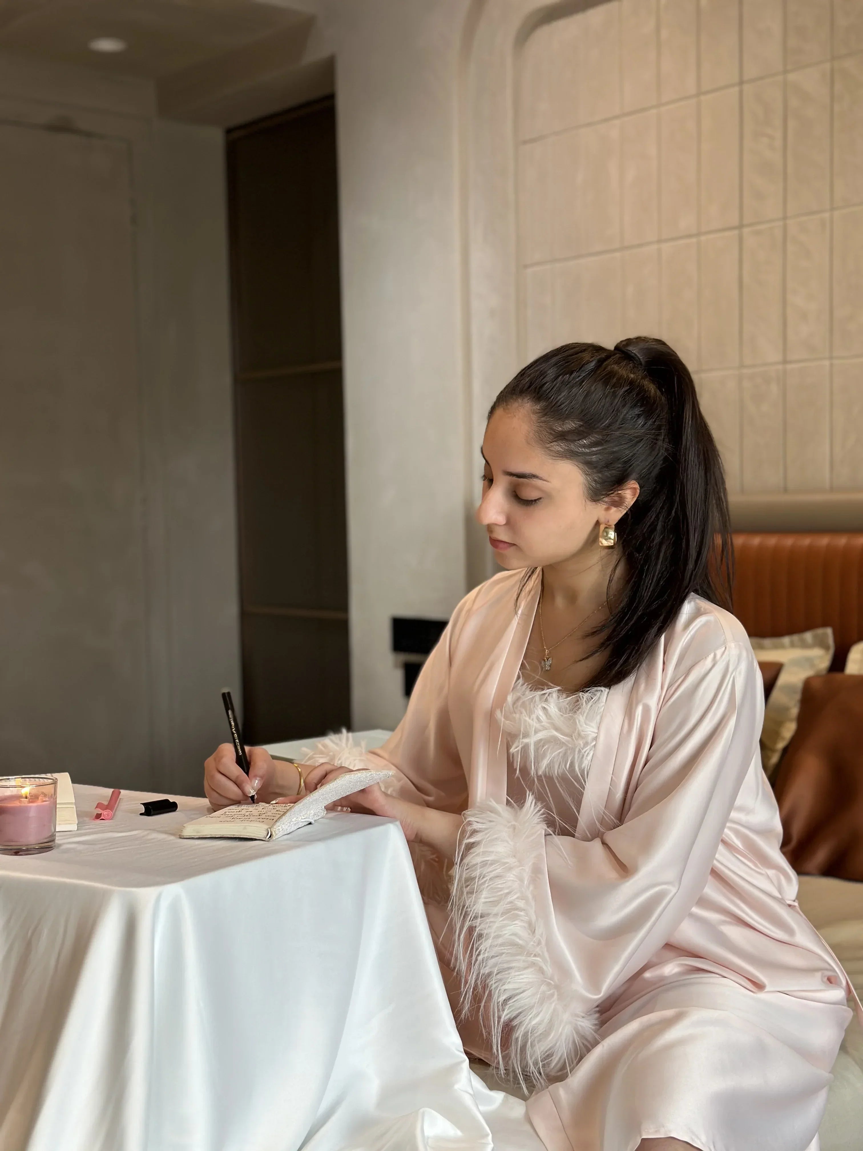 woman wearing comfortable night suit journaling and getting ready for bed.
