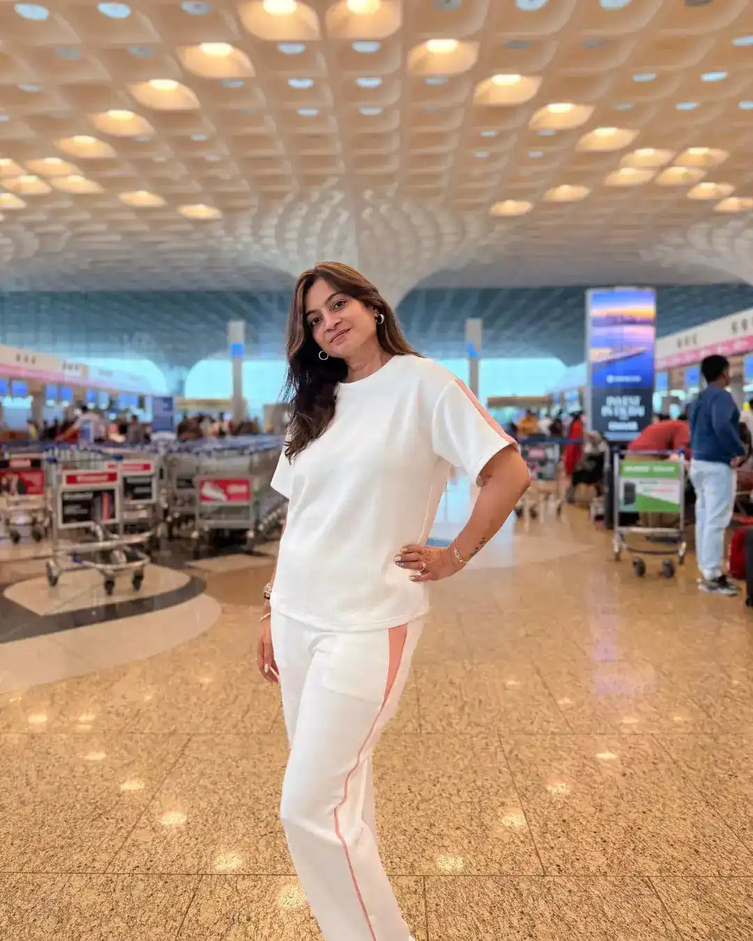 woman wearing white velure scuba cotton co-ord set at the airport 