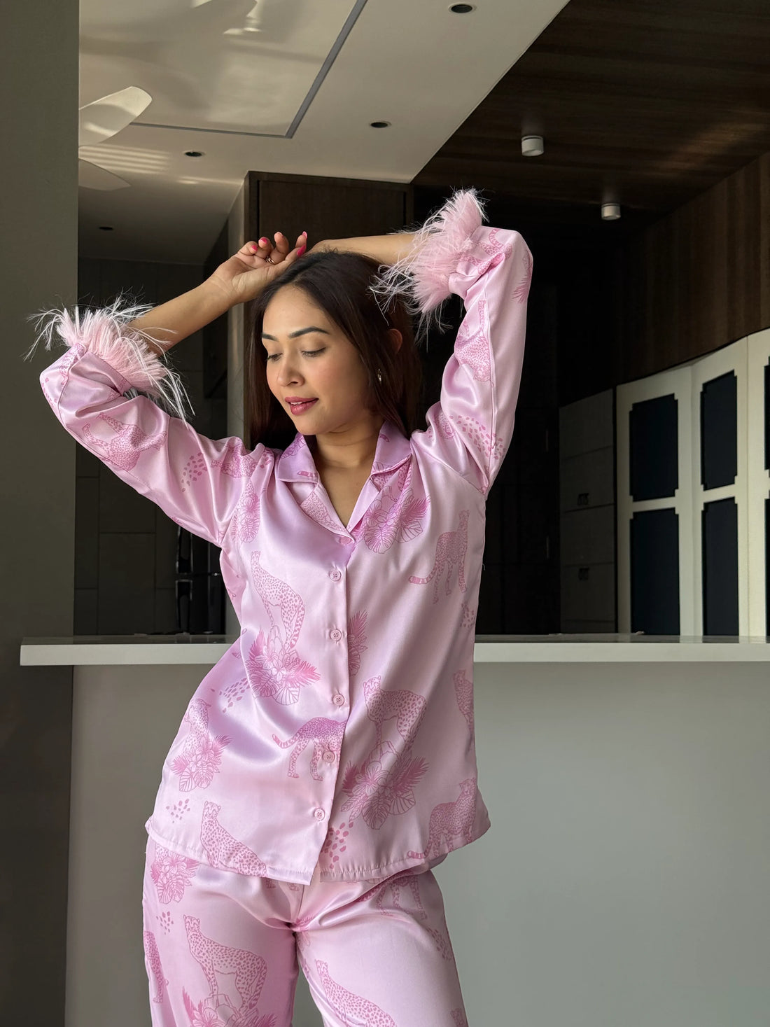 woman wearing Velure Trendy Cheetah Print Satin Sleepwear Set in a living room