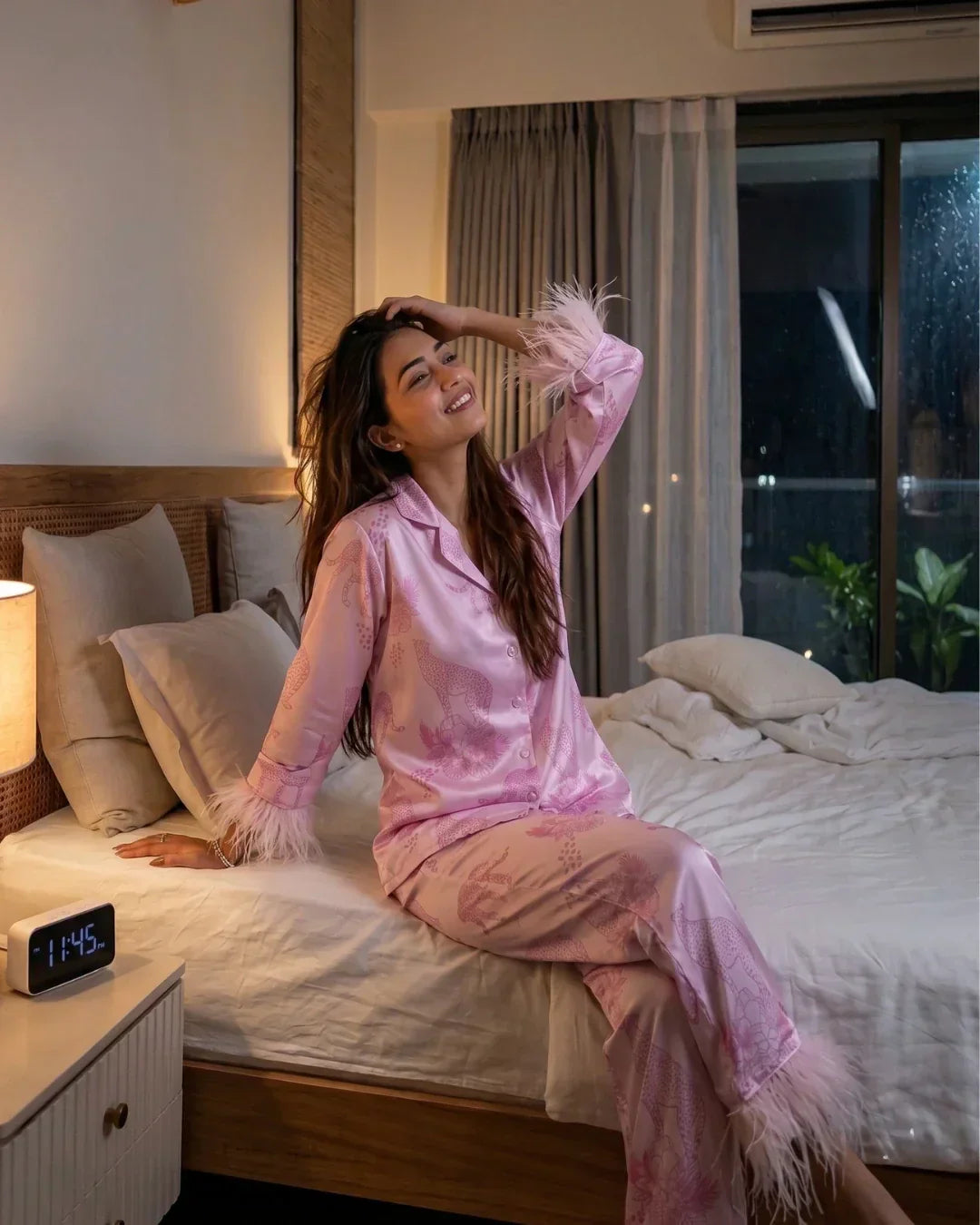 woman wearing Velure satin night suit set on her bed in the bedroom in Indian summer feeling cool and comfortable.