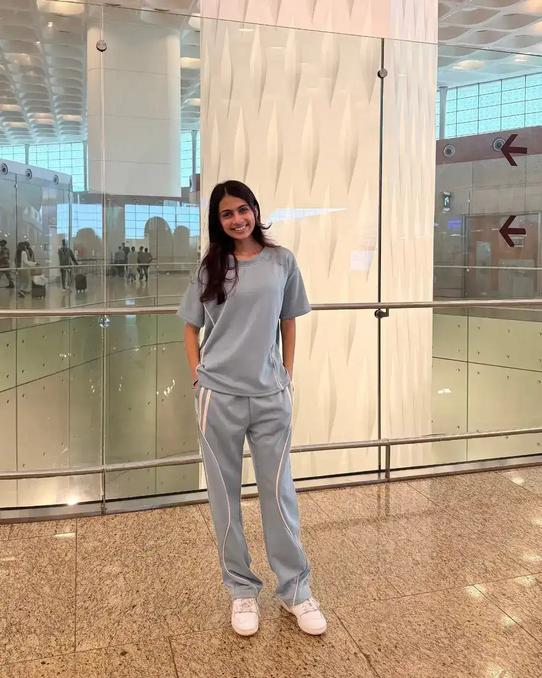 woman wearing blueish grey travel scuba cotton co-ord set at airport 