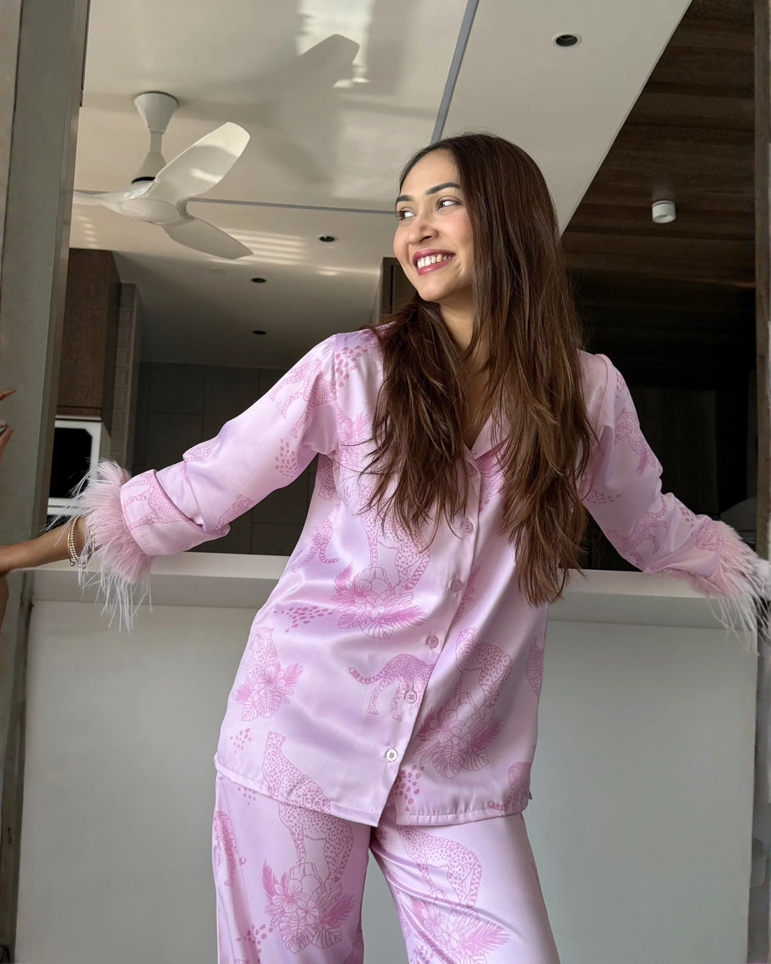 woman wearing Velure Cheetah Print Satin Fur NIght suit looking happy and comfortable