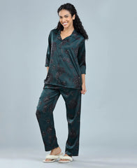 Velure Delightful Floral Satin Print Night Suit - Velure, Long Top and Pant, Elevate your weekend attire with Velure's Delightful Floral Satin Print Night Suit. Made from luxurious satin material, this set offers unparalleled comfort and softness. The dark green floral design brings a sense of cheer to the outfit. Including a 3/4 sleeve top and full-length pants with an elastic waistband, this suit guarantees a comfortably snug fit. Enjoy a peaceful night's rest accompanied by pleasant dreams.