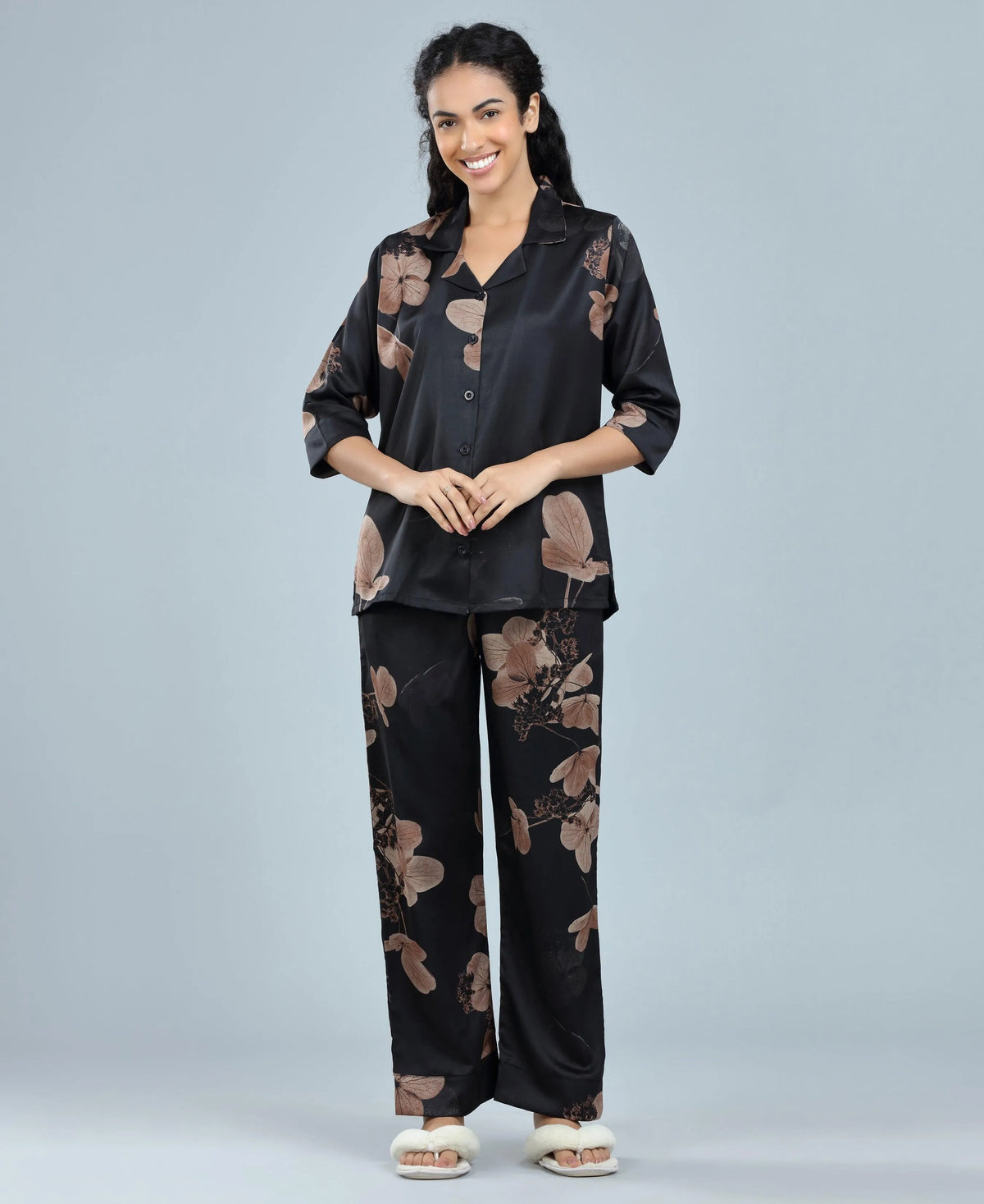 Velure Glossy Black Floral Print Satin Night Suit - Velure, Long Top and Pant, Elevate your weekend wardrobe with Velure's Glossy Black Floral Satin Print Night Suit. Crafted from silky smooth satin, this set guarantees unmatched comfort and softness. The vibrant floral print adds a touch of joy to the ensemble. Featuring a 3/4 sleeve shirt and full-length pants with an elastic waistband, this suit ensures a snug and cozy fit. Indulge in a peaceful sleep accompanied by pleasant dreams.