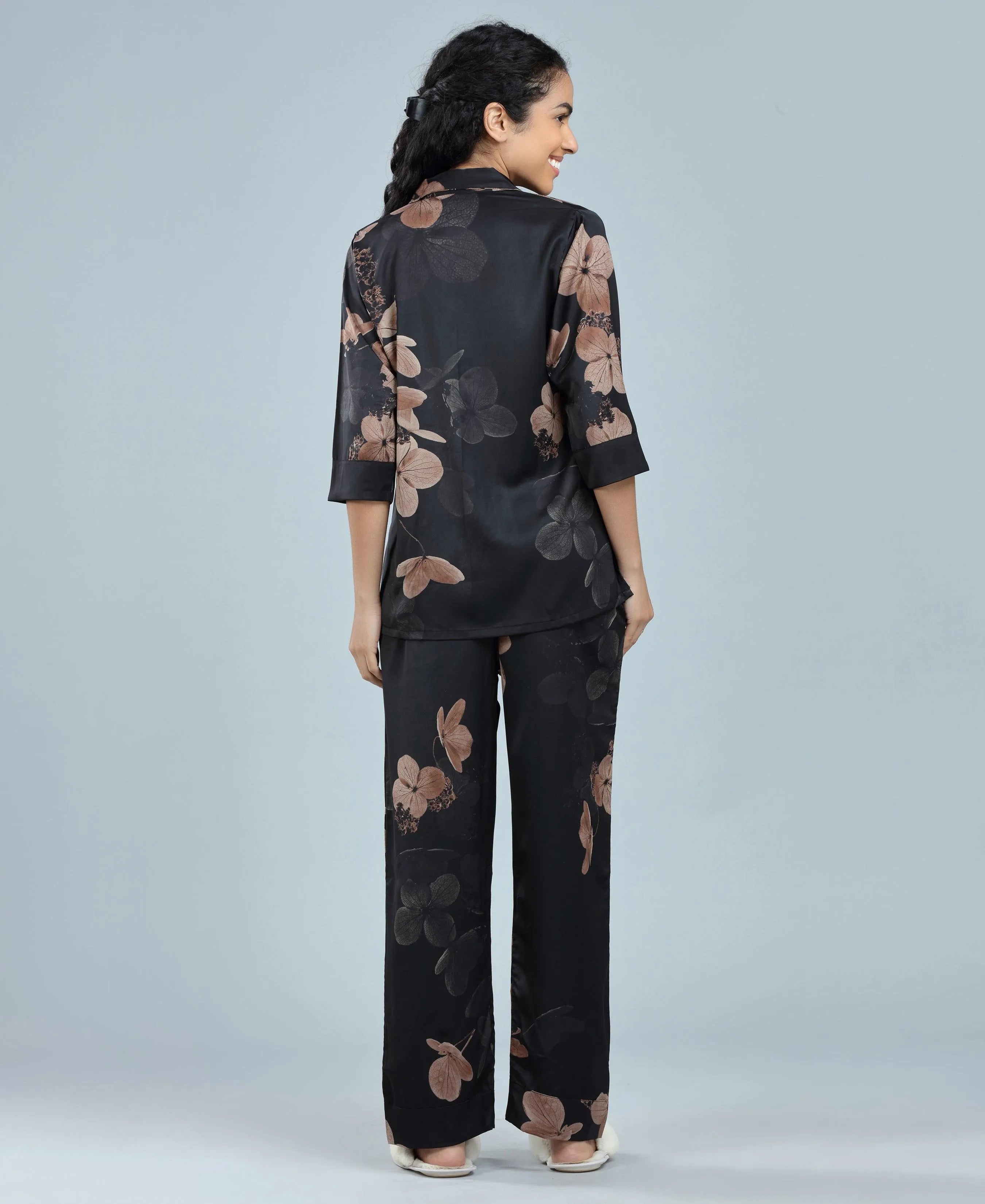 Velure Glossy Black Floral Print Satin Night Suit - Velure, Long Top and Pant, Elevate your weekend wardrobe with Velure's Glossy Black Floral Satin Print Night Suit. Crafted from silky smooth satin, this set guarantees unmatched comfort and softness. The vibrant floral print adds a touch of joy to the ensemble. Featuring a 3/4 sleeve shirt and full-length pants with an elastic waistband, this suit ensures a snug and cozy fit. Indulge in a peaceful sleep accompanied by pleasant dreams.